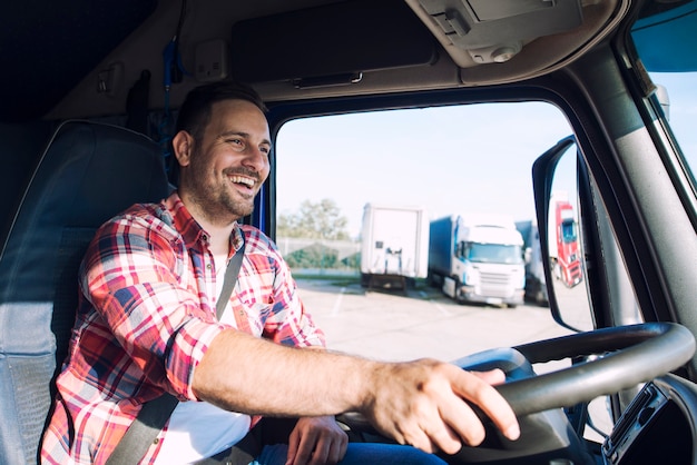 professional-middle-aged-truck-driver-casual-clothes-driving-truck-vehicle-delivering-cargo-destination_342744-1286